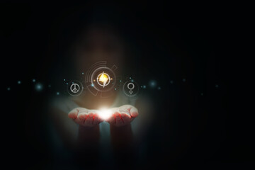 A girl is holding an energy icon in their hands, with other tech icons floating around them on a dark background. The lighting is soft and focused on their hand, freedom concept