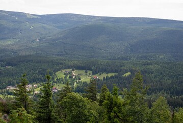 Views from Wysoki Kamien peak at 1058m in the Jizera Mountains reveal breathtaking landscapes of rolling hills.