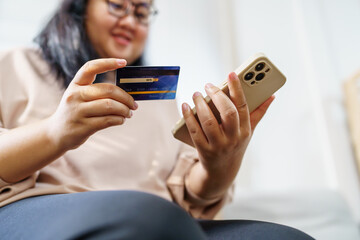 Woman shopping on Smartphone holding credit card for Internet online e-commerce shopping spending money Online shopping Mobile phone concept