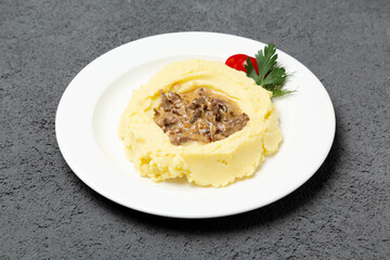Beef goulash with mashed potatoes. On a gray background. Photo for the menu.
