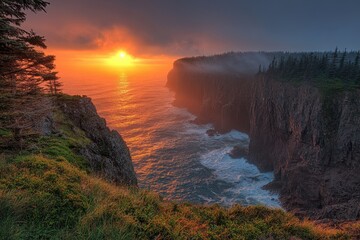 Sunrise illuminating dramatic cliffs and ocean waves on cape breton island