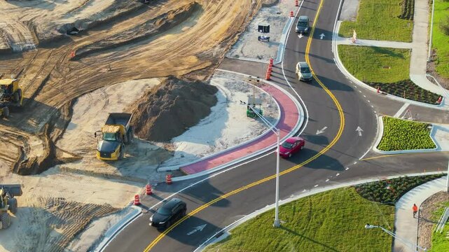Roundabout intersection construction in North Port, Florida. Development of American road circle with moving traffic cars. Urban circular transportation crossroads