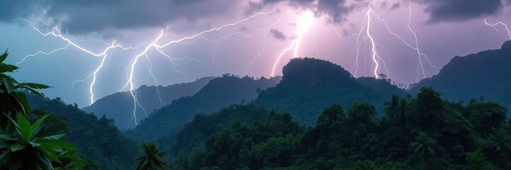 Lightning strikes over a lush jungle and mountain range