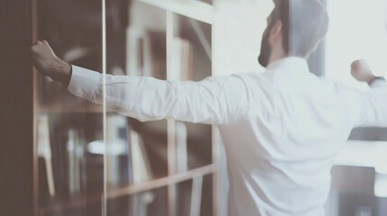Office worker taking a break to do stretches in a modern office setting, promoting work-life balance and physical well-being in the workplace.