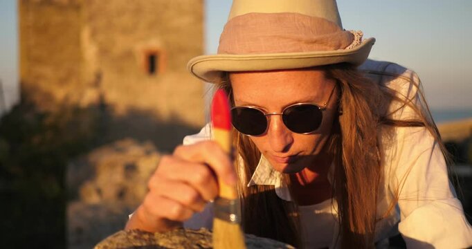 History. Archaeology. Africa. Roman Empire. Portrait of a female archaeologist at work in the rays of a bright sunset