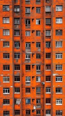 Striking orange color dominates the apartment building facade, showcasing urban architecture with a patchy, weathered texture.