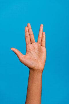 Cropped close up photo of lady hand demonstrate vulcan salute gesture isolated on blue color background