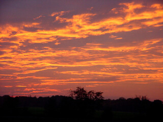 Gorgeous sunset with beautiful colors, clouds and silhouettes, at the end of a warm summer day.