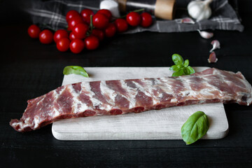 Fresh raw pork ribs. With spices. on a wooden background