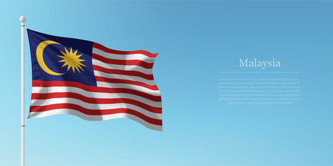 Waving Flag of Malaysia Against Clear Blue Sky Copyspace