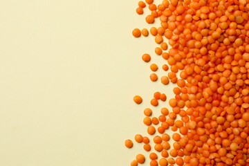 Red lentils in a bowl on color background 