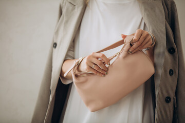 Model, woman, hands close-up with handbag in dress and jacket on white background