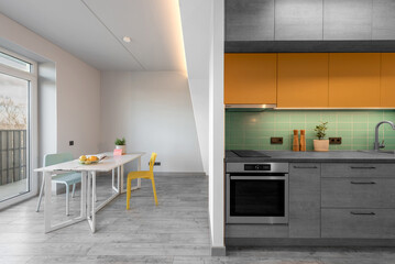 Modern Kitchen Interior Stylish Furniture Hardwood Floor. Oven, Sink, Flower, Minimalistic Interior Design. LED Lights, Hardwood Floor. White Walls. Open Space, Dinig Table Widows Flowers