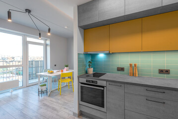 Modern Kitchen Interior Stylish Furniture Hardwood Floor. Oven, Sink, Flower, Minimalistic Interior Design. LED Lights, Hardwood Floor. White Walls. Open Space, Dinig Table Widows Flowers