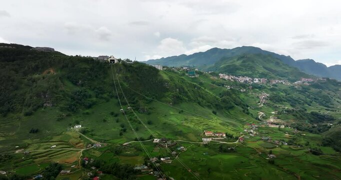 Aerial over Fansipan cable car ride cables spanning lush Sapa Muong Hoa Valley