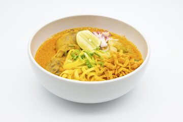 KhaoSoi, Thai Northern Curry Noddle Soup with chicken, Thai traditional food, Northern style on the wooden table
