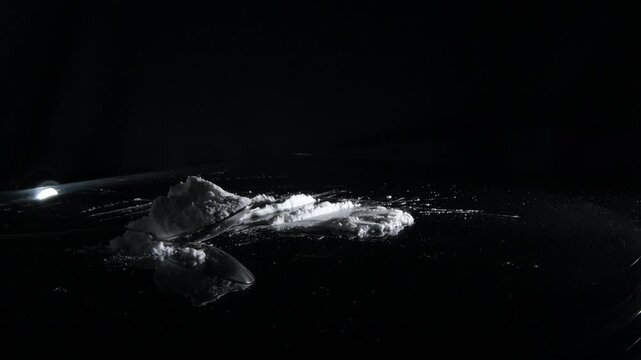 Cocaine in lines and spoon over a crystal