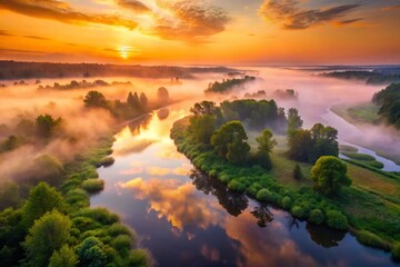 Obraz premium Misty River Sunrise Aerial View - Enchanting Nature at Dawn with Fog and Reflection Over Water in Low Light Conditions