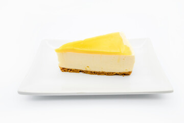Lemon cheesecake on the plate isolate on white background