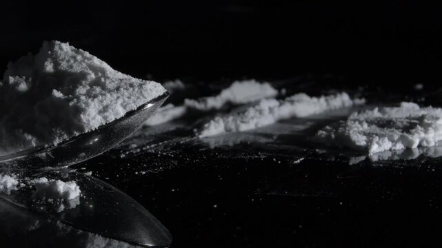 Powder of cocaine in a spoon and lines