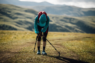 Sports injured knee woman trail runner running in grassland