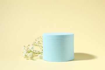 Podium and white gypsophila flowers on a colored background