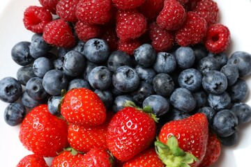 Different fresh ripe berries in bowl 