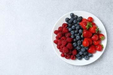 Different fresh ripe berries in bowl 