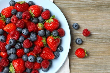 Different fresh ripe berries in bowl 