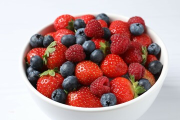 Different fresh ripe berries in bowl 