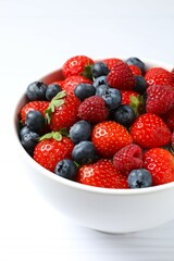 Different fresh ripe berries in bowl 