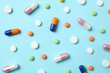 Various medicine pills on color background