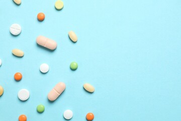 Various medicine pills on color background