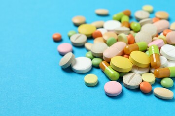 Various medicine pills on color background