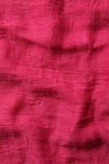 Pink fabric background, top view
