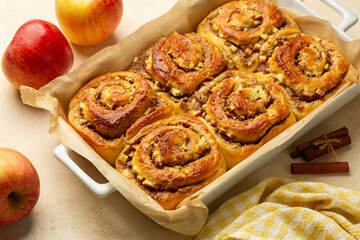 Homemade baked Rolls Buns with apples, walnut and cinnamon. Beige table background.