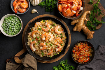 Top view of Homemade asian style prawns or shrimp fried rice with fried eggs, vegetables, onion,...