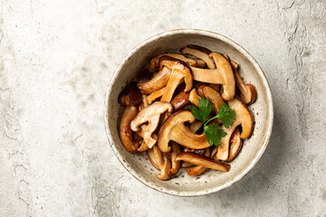 Top view of Fried with garlic oak mushroom. The shiitake or black forest mushrooms is an edible...