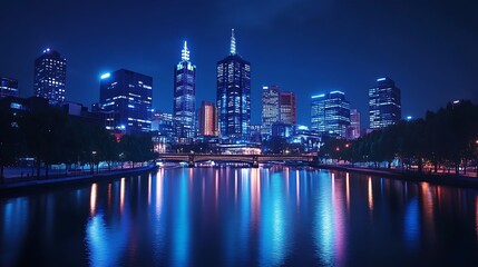 Nighttime cityscape with illuminated skyscrapers reflected in a calm river