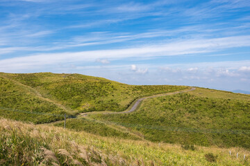 Naklejka premium Green lanscape with mountain Aso background, view at the top of mountain from Daikanbō Mount Aso, Aso, Kumamoto, Kyushu, Japan