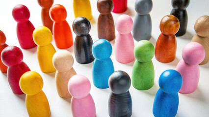 Colorful wooden meeple pawns symbolize a group of people and the diversity of the population