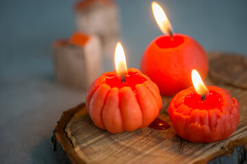 Small bright orange candles in the shape of a tangerine