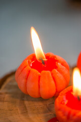 Small bright orange candles in the shape of a tangerine