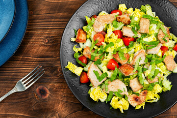 Meat salad on wooden table.