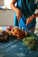 carving a beautifully roasted turkey, a centerpiece of the Christmas feast. This moment reflects the cherished traditions of holiday cooking and the warmth of family celebrations