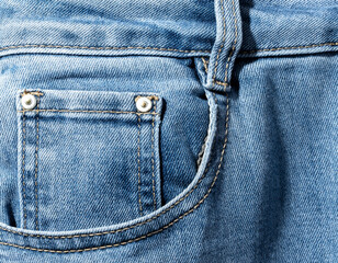 Front pocket and small pocket of blue jeans pants. Macro close up.