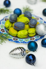 Christmas or New Year green and blue homemade cookies called Nuts stuffed with condensed milk and walnuts surrounded with Christmas balls 