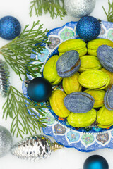 Christmas or New Year green and blue homemade cookies called Nuts stuffed with condensed milk and walnuts surrounded with Christmas balls 