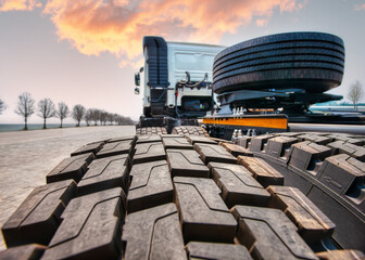 truck head with new tires on the road at sunset view from behind back, © poco_bw