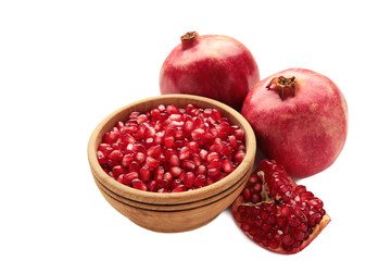 Open pomegranates, and pomegranate seeds in bowl isolated on white background.